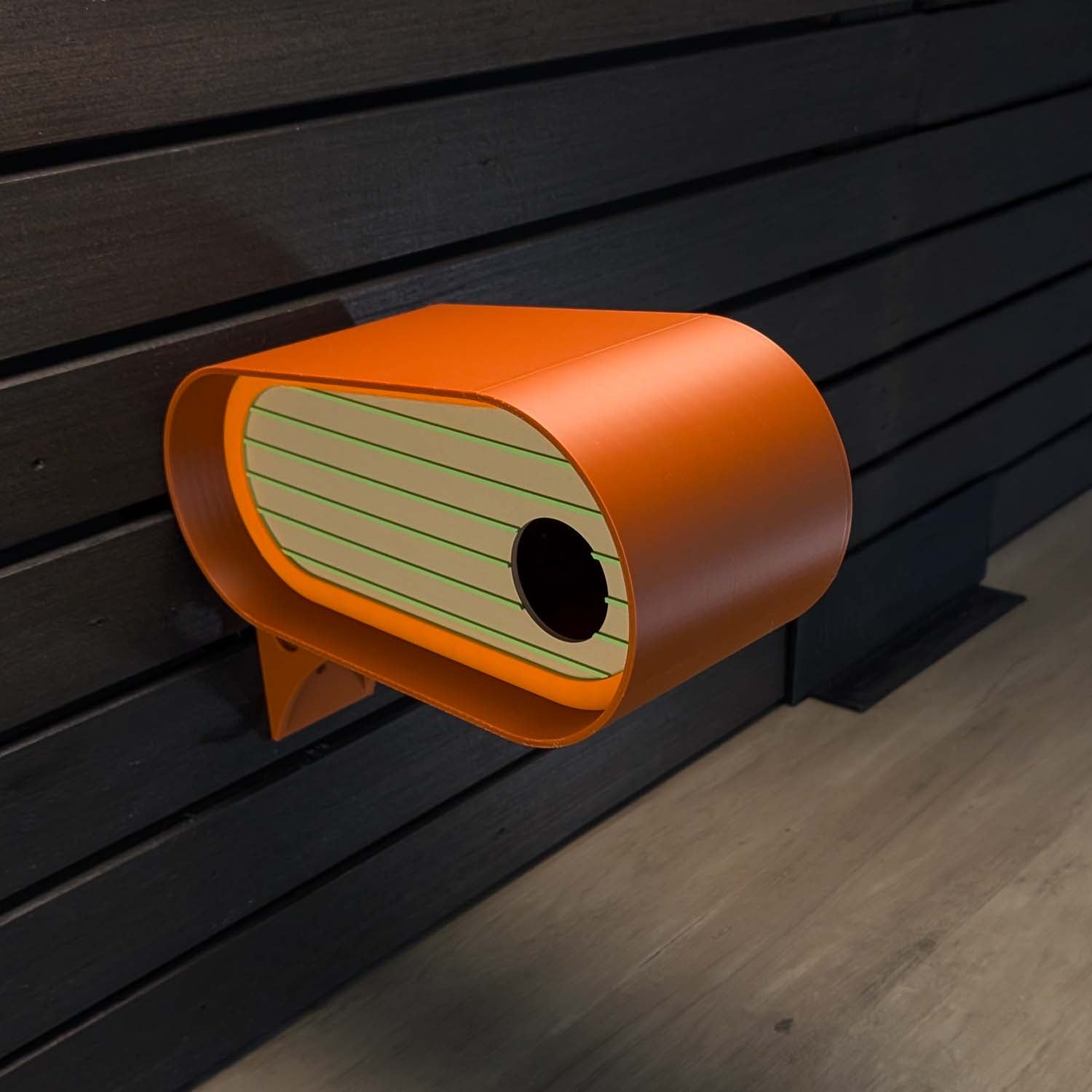 Orange birdhouse attached to a wooden wall