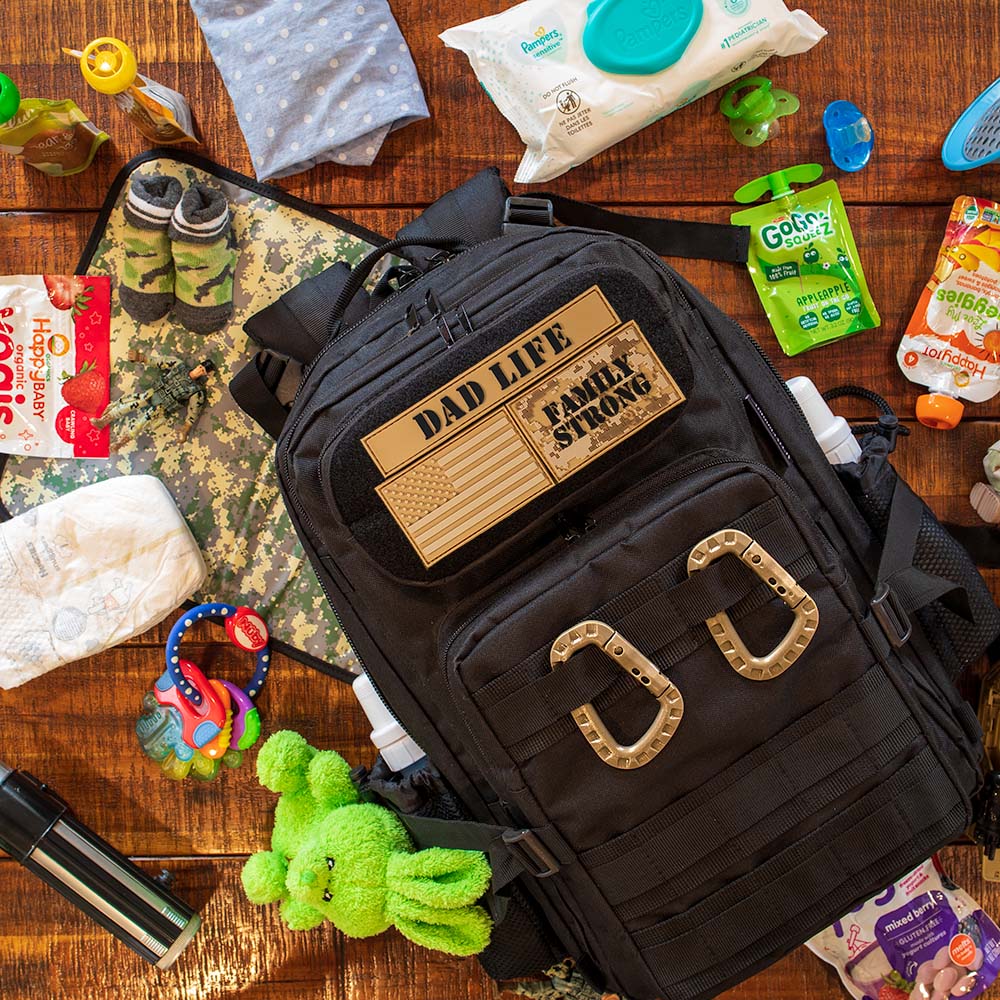 Mens diaper bag backpack on a table with Dad Life Morale Patches