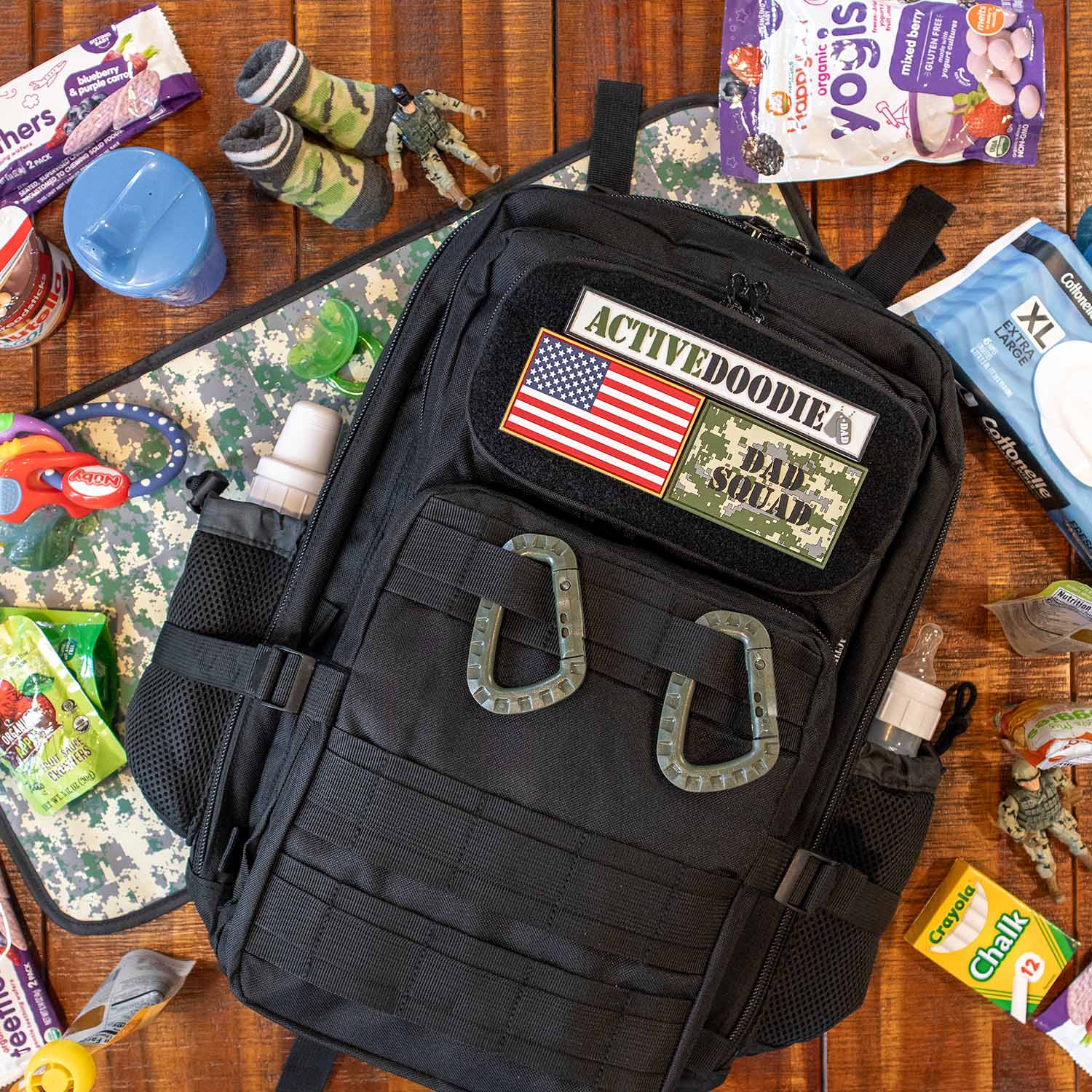 Diaper bag for dad with USA Velcro patch laying on a table with changing mat
