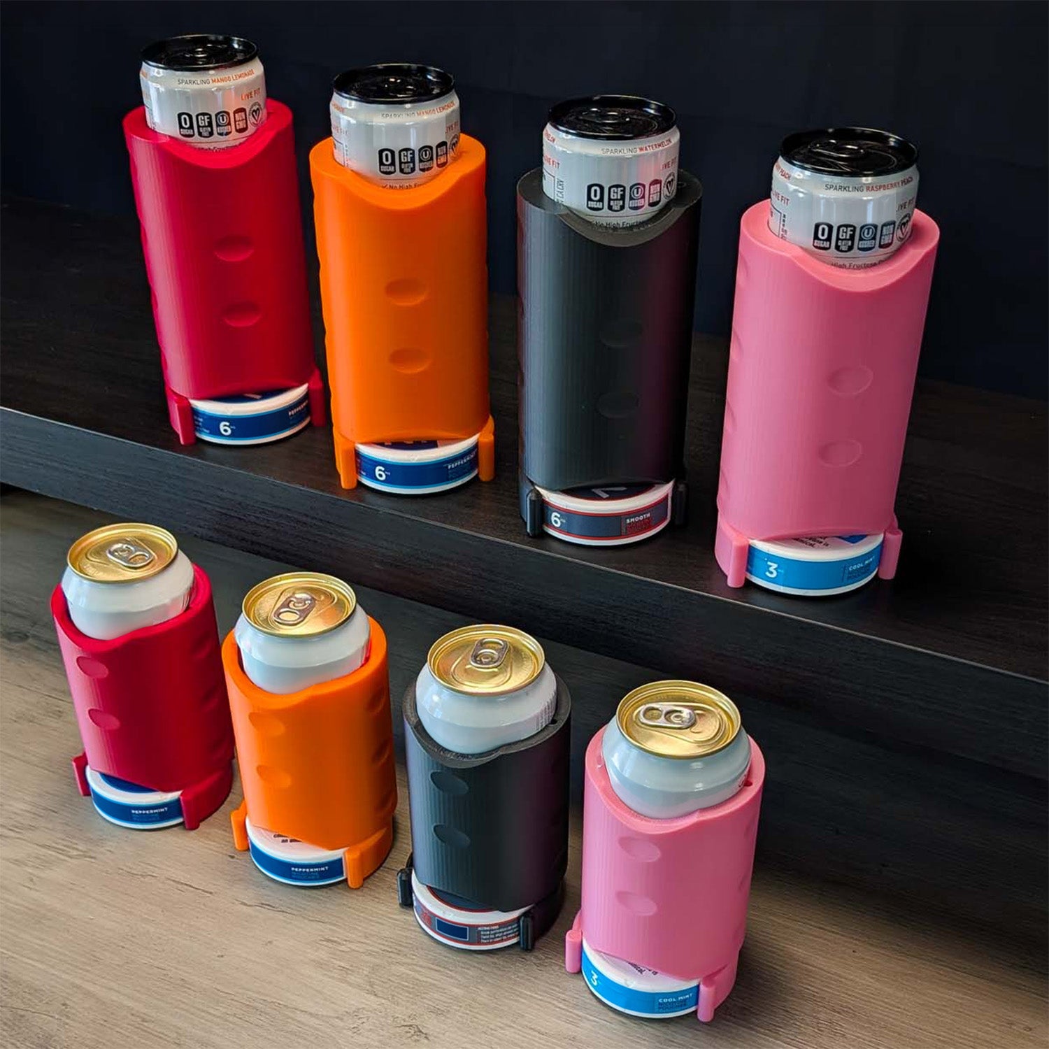 Colorful can coolers on a wooden surface and dark background. "The Stacker" by ADG42